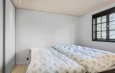 a bed in a white room with a window at Awesome Home In Roslev With Kitchen in Roslev