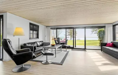 a living room with a couch and chairs and a table at Awesome Home In Roslev With Kitchen in Roslev