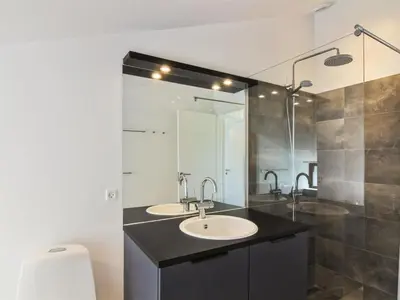 a bathroom with a sink and a shower and a toilet at Holiday Home Kristiina - 500m from the sea by Interhome in Saltum