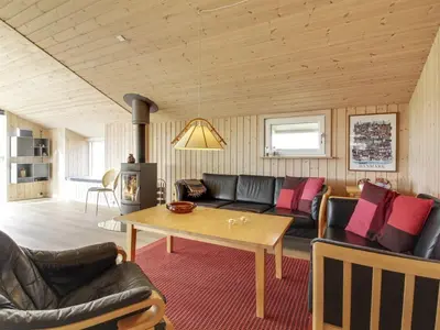 a living room with a couch and a table at Holiday Home Emelia - 50m from the sea by Interhome in Torsted