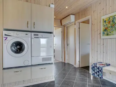 a laundry room with a washer and dryer at Holiday Home Emelia - 50m from the sea by Interhome in Torsted