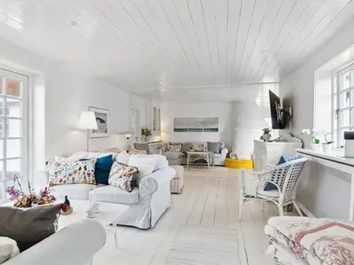 a living room with white furniture and a white ceiling at Holiday Home Jeppe - 200m from the sea by Interhome in Blokhus