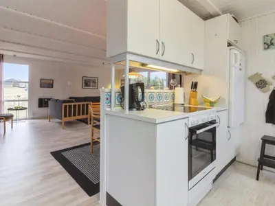 a kitchen and living room with a counter top at Holiday Home Florencia - 450m from the sea by Interhome in Løkken