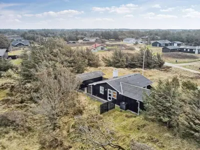 an aerial view of a black house in a village at Holiday Home Florencia - 450m from the sea by Interhome in Løkken