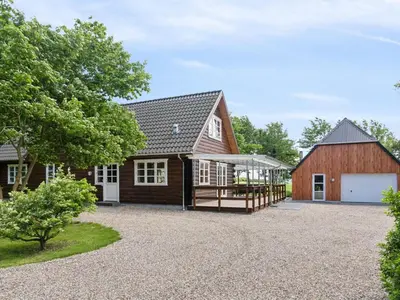 a house with a barn and a garage at Holiday Home Månviva - 150m to the fjord by Interhome in Redsted