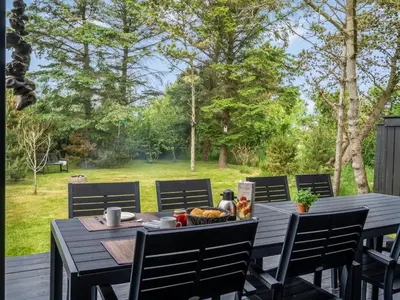 a wooden table with a bowl of food on it at Holiday Home Jukka - 2km from the sea by Interhome in Snedsted