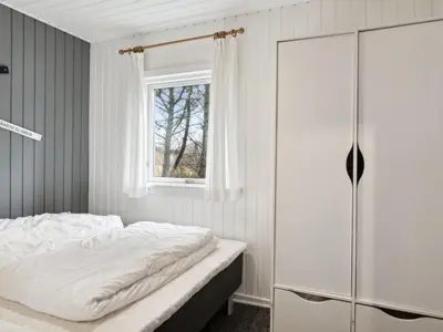 a bedroom with a bed and a window at Holiday Home Jukka - 2km from the sea by Interhome in Snedsted