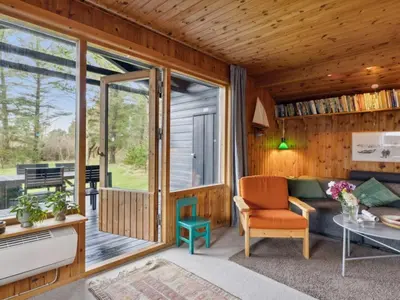 a living room with a couch and a table at Holiday Home Jukka - 2km from the sea by Interhome in Snedsted