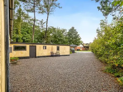 a house with a gravel driveway at Holiday Home Birtir - 750m from the sea by Interhome in Hanstholm