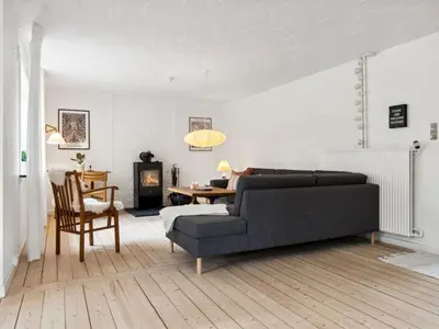 a living room with a couch and a table at Holiday Home Birtir - 750m from the sea by Interhome in Hanstholm