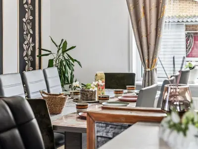 a dining room with a table and chairs at Holiday Home Elara - 300m from the sea by Interhome in Thyholm