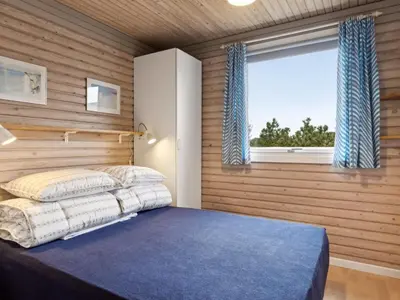 a bedroom with a bed and a window at Holiday Home Selenia - 1km from the sea by Interhome in Saltum