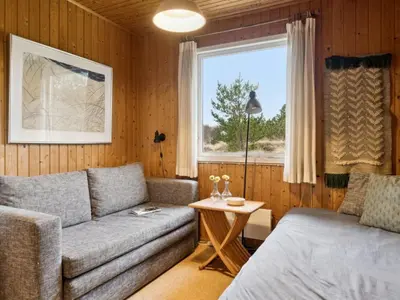a living room with a couch and a window at Holiday Home Swenki - 700m from the sea by Interhome in Saltum