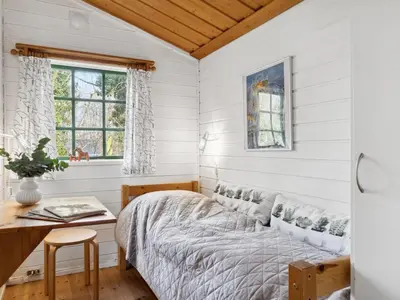 a bedroom with white walls and a bed and a desk at Holiday Home Bonde - 800m to the fjord by Interhome in Farsø