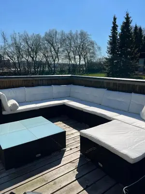 a white couch sitting on top of a deck at Hyggeligt golfhus i Himmerland in Farsø