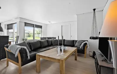 a living room with a black couch and a table at Lovely Home In Vestervig With Kitchen in Vestervig