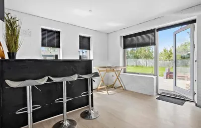 a living room with a black counter and a table at Lovely Home In Vestervig With Kitchen in Vestervig