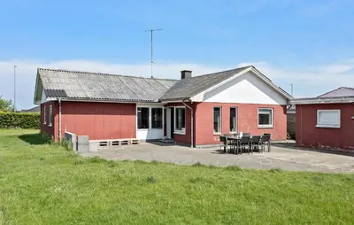 a red and white house with a table and chairs at Lovely Home In Vestervig With Kitchen in Vestervig