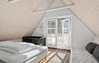 a attic bedroom with a bed and a window at 2 Bedroom Gorgeous Home In Saltum in Saltum