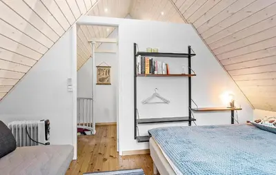 a bedroom with a bed and a book shelf at 2 Bedroom Gorgeous Home In Saltum in Saltum