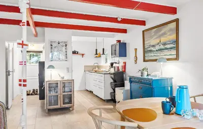 a kitchen with a table and a blue refrigerator at 2 Bedroom Gorgeous Home In Saltum in Saltum