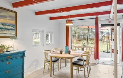 a kitchen and dining room with a table and chairs at 2 Bedroom Gorgeous Home In Saltum in Saltum