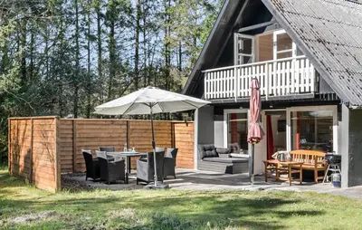a patio with an umbrella and a table and chairs at 2 Bedroom Gorgeous Home In Saltum in Saltum