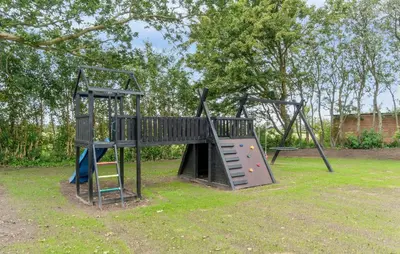 a playground with a slide and a climbing frame at Nice Home In Spøttrup With Sauna in Spottrup