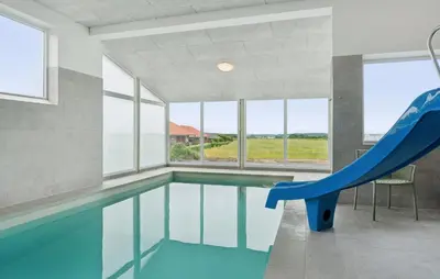 a swimming pool with a slide in a house at Nice Home In Spøttrup With Sauna in Spottrup