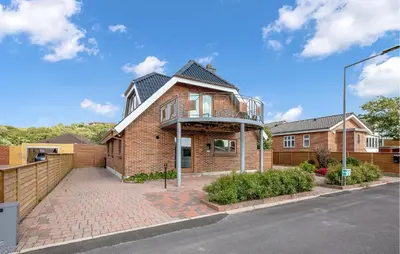 a brick house with a balcony on top of it at Pet Friendly Home In Lemvig With Wifi in Lemvig