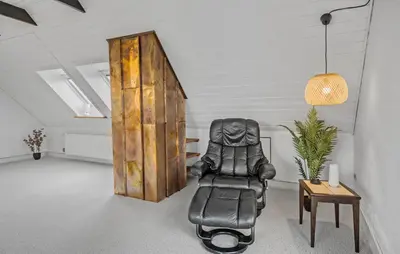 a black leather chair in a room with a door at Pet Friendly Home In Lemvig With Wifi in Lemvig