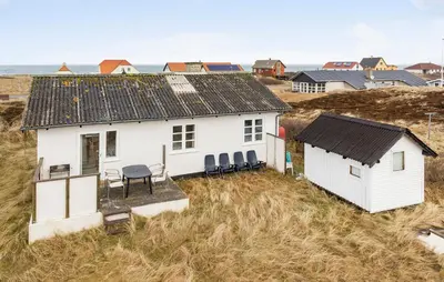 a white house in a field of grass at 3 Bedroom Pet Friendly Home In Frøstrup in Frøstrup