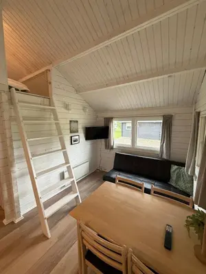 a living room with a couch and a table at Himmerland camping & Feriecenter in Års