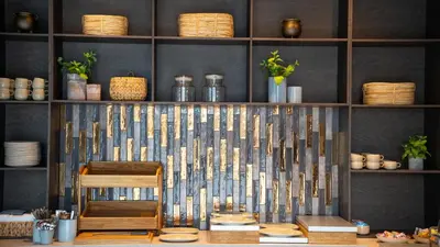 a room with a table and a chair and shelves at Hotel Nørreport in Holstebro