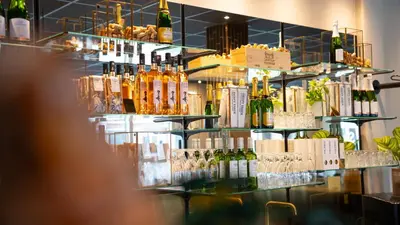 a bar with bottles of wine and glasses at Hotel Nørreport in Holstebro