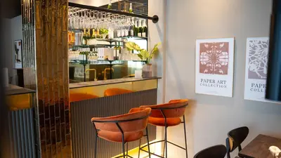 a bar with orange chairs in a restaurant at Hotel Nørreport in Holstebro