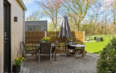 a patio with an umbrella and a table and chairs at Stunning Home In Spøttrup With Wifi in Spottrup
