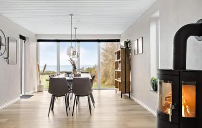 a dining room with a table and a fireplace at Stunning Home In Spøttrup With Wifi in Spottrup