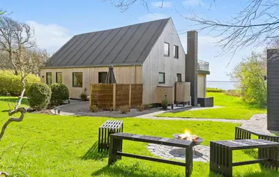 a house with a fire pit in front of it at Stunning Home In Spøttrup With Wifi in Spottrup