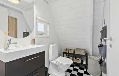 a bathroom with a toilet and a sink and a mirror at Awesome Home In Farsø With Wifi in Farsø