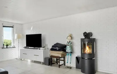 a living room with a fireplace and a tv at Beautiful Home In Thisted With Wifi in Thisted