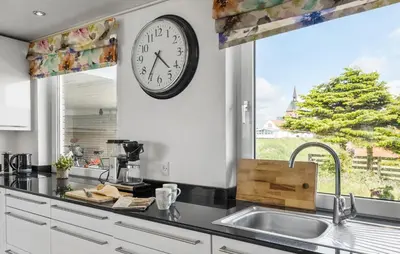a kitchen with a clock on the wall and a sink at Beautiful Home In Thisted With Wifi in Thisted