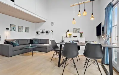 a living room with a couch and a table and chairs at Amazing Apartment In Vestervig in Vestervig