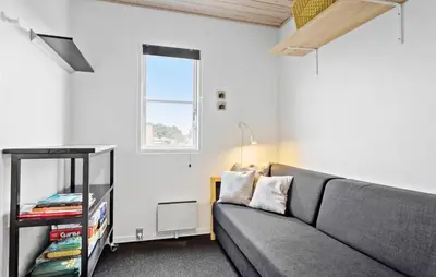 a living room with a gray couch and a window at Amazing Apartment In Vestervig in Vestervig