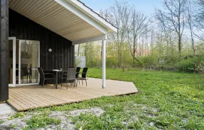 a wooden deck with a table and chairs on it at 4 Bedroom Nice Home In Vinderup in Vinderup