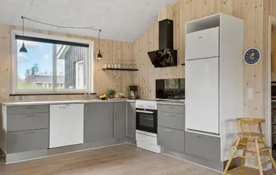 a kitchen with a white refrigerator and a window at 4 Bedroom Nice Home In Vinderup in Vinderup