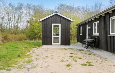 a black shed with a desk in front of it at 4 Bedroom Nice Home In Vinderup in Vinderup