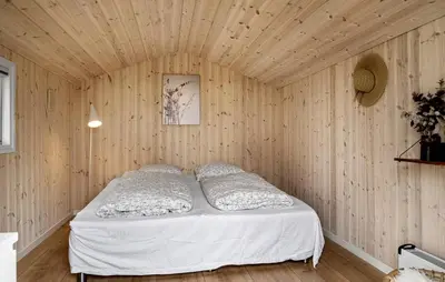 a bedroom with a bed in a wooden wall at Cozy Home In Vestervig With Wifi in Vestervig