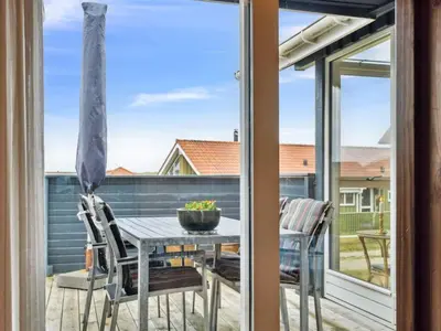 a patio with a table and chairs on a balcony at Holiday Home Dolores - 200m from the sea by Interhome in Torsted