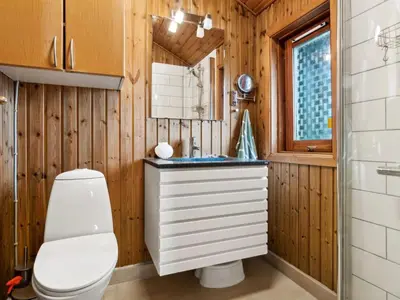 a bathroom with a toilet and a sink at Holiday Home Dolores - 200m from the sea by Interhome in Torsted